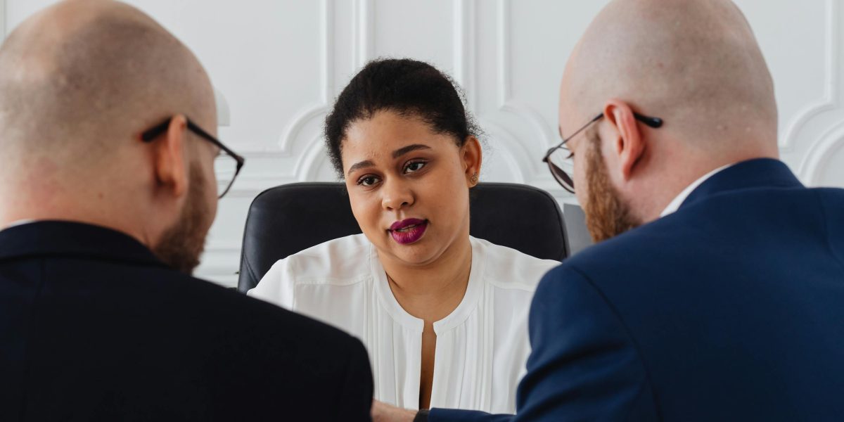 Individuals engaged in a thoughtful discussion, reflecting the challenges and ethical considerations surrounding new AI technologies.