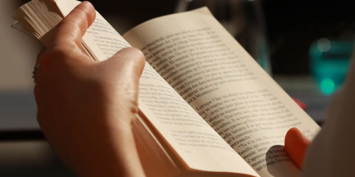 A person engrossed in reading, suggesting the captivating and sometimes terrifying nature of early sci-fi.