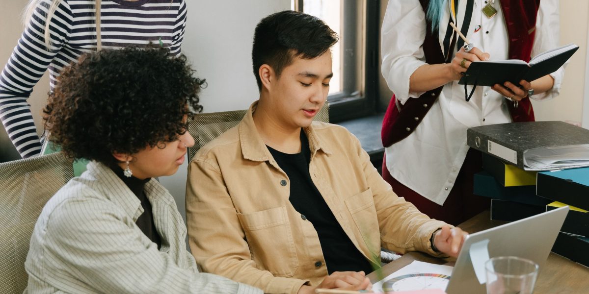 A diverse team collaborates, discussing the ethical implications and guidelines for developing advanced AI systems.